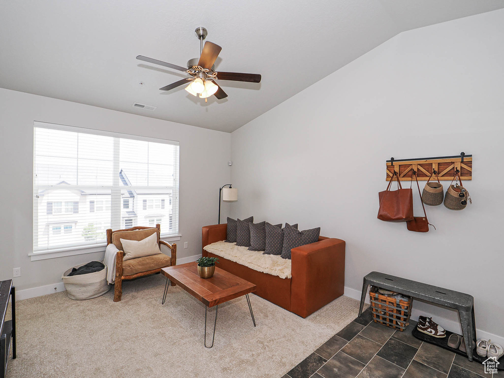 Living area with vaulted ceiling and ceiling fan