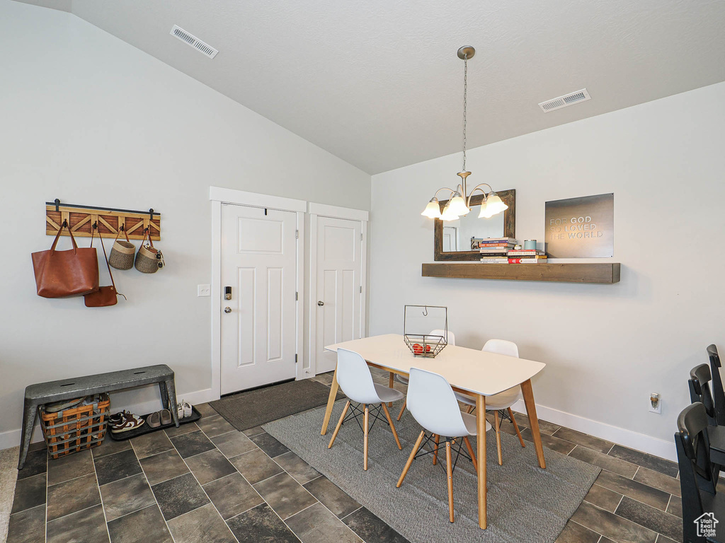 Dining room with a chandelier and lofted ceiling