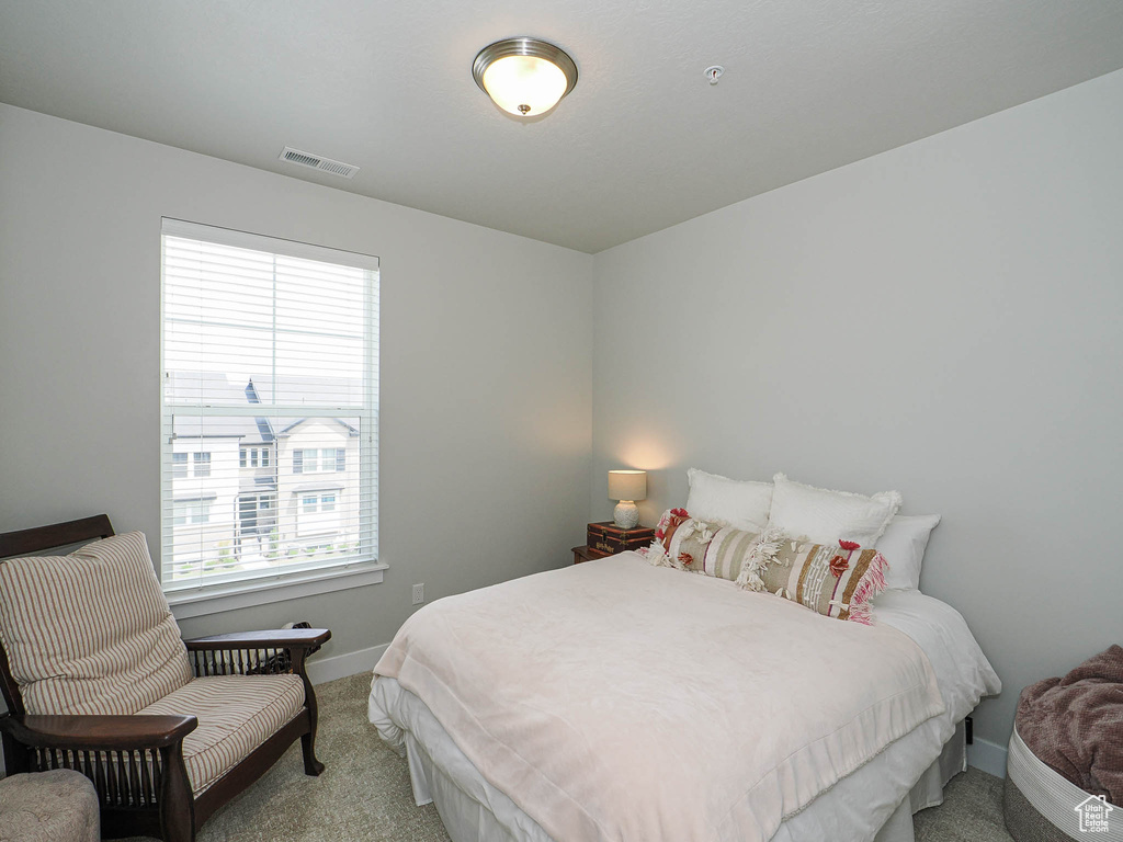 Carpeted bedroom featuring baseboards