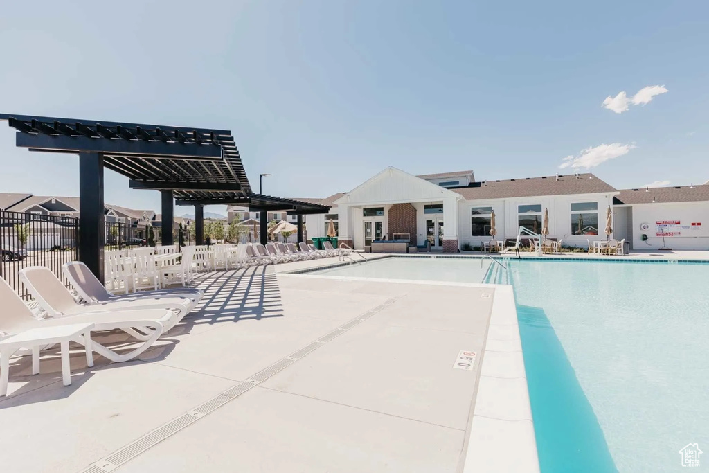 Community pool featuring a pergola and a patio area