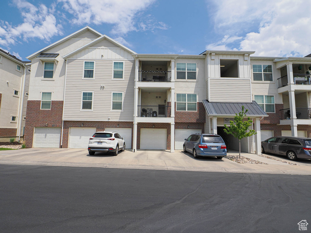 View of building exterior with a garage and driveway