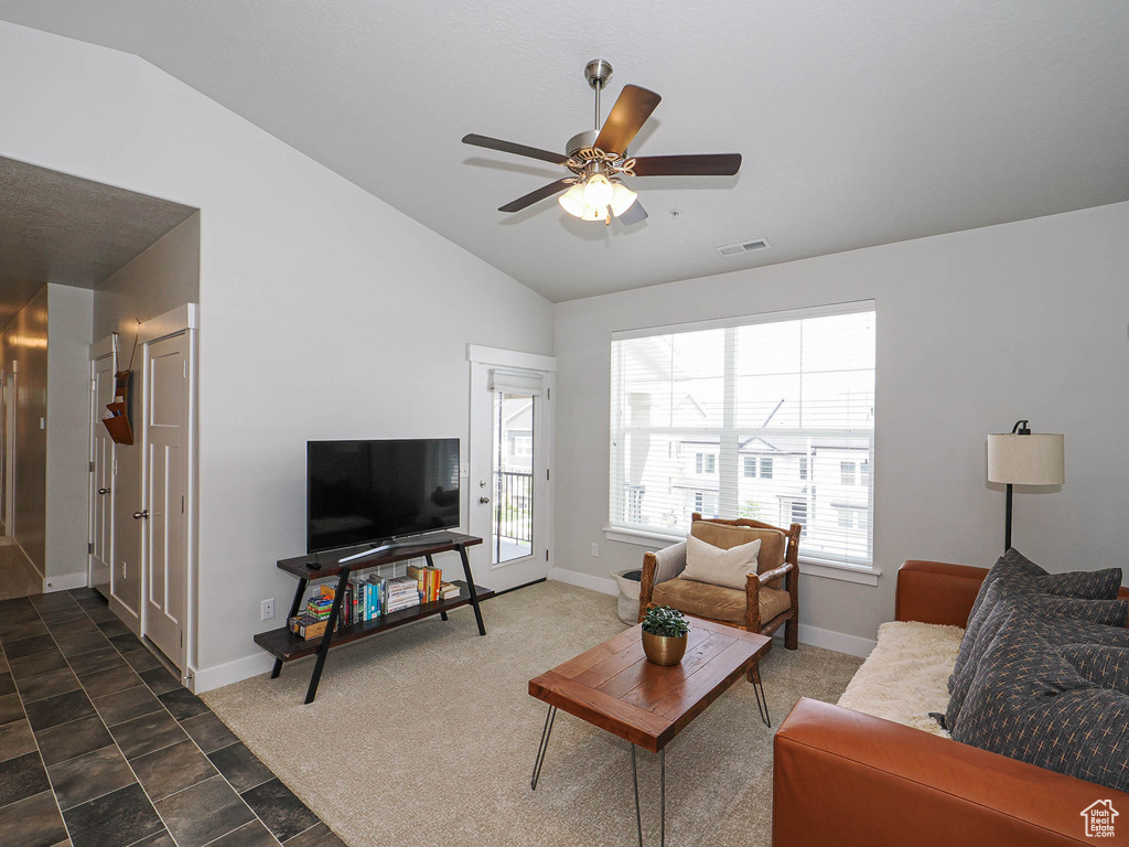 Living area with vaulted ceiling and ceiling fan