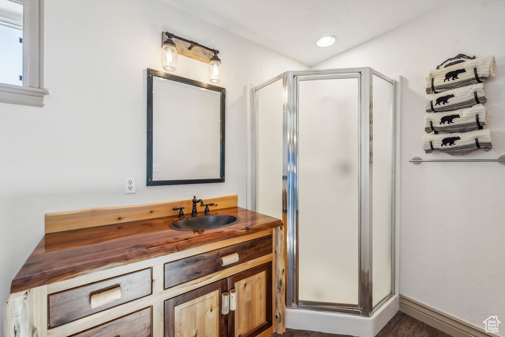 Bathroom with a shower stall and vanity