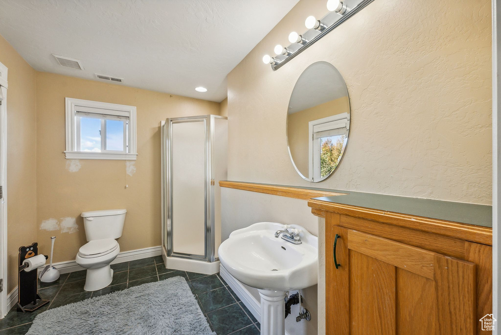 Bathroom featuring a stall shower and tile patterned flooring