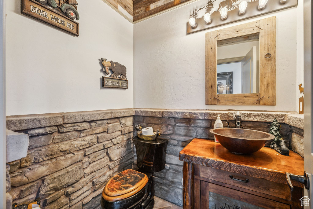 Bathroom featuring a wainscoted wall and vanity