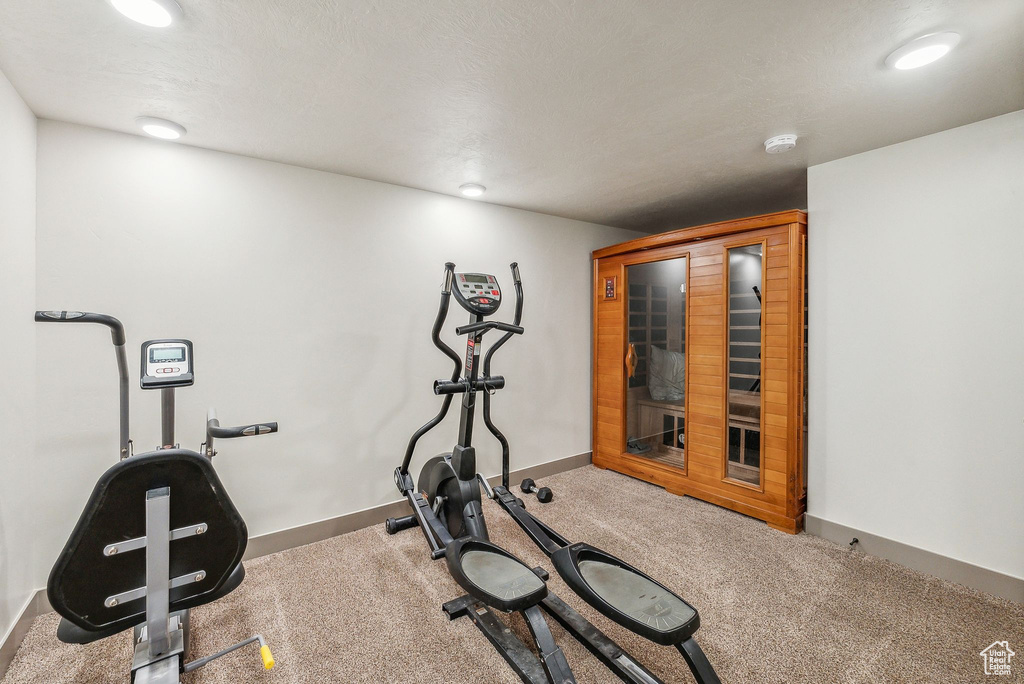 Exercise area with a relaxing sauna, carpet, and recessed lighting
