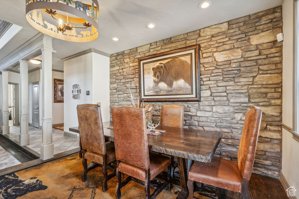 Dining room with decorative columns and recessed lighting