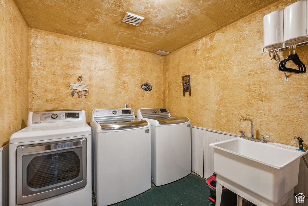 Laundry area featuring washer and dryer and wainscoting