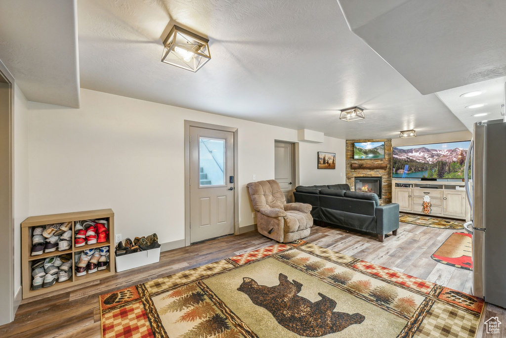Living area with a large fireplace and wood finished floors
