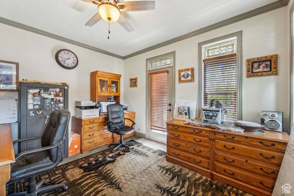 Tiled office space featuring a ceiling fan and crown molding