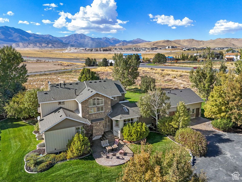 Aerial view of property and surrounding area featuring mountains