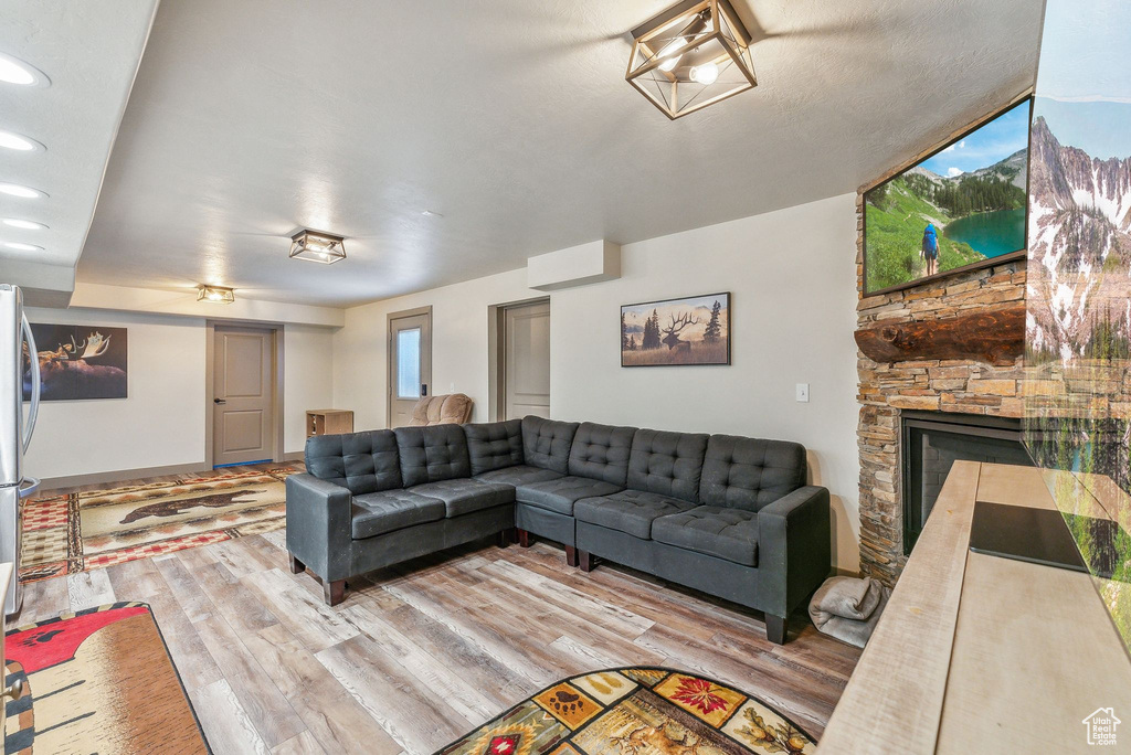 Living area featuring wood finished floors, a fireplace, and recessed lighting