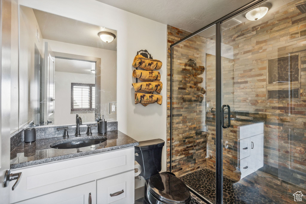 Bathroom with vanity and a stall shower