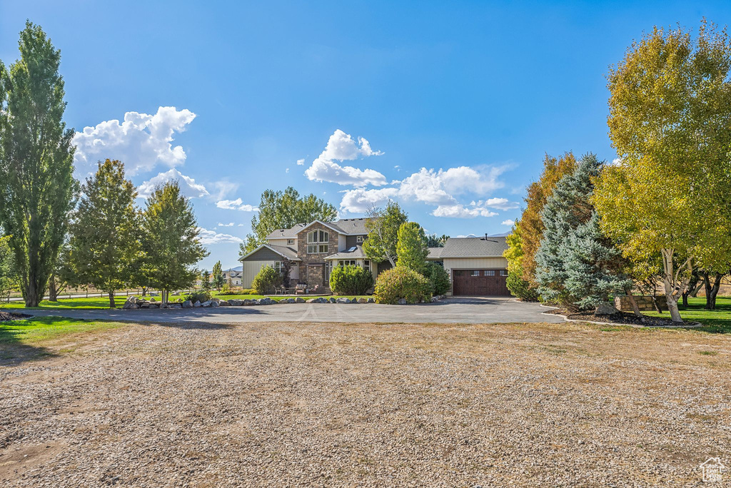 View of front of home featuring stone siding and a garage