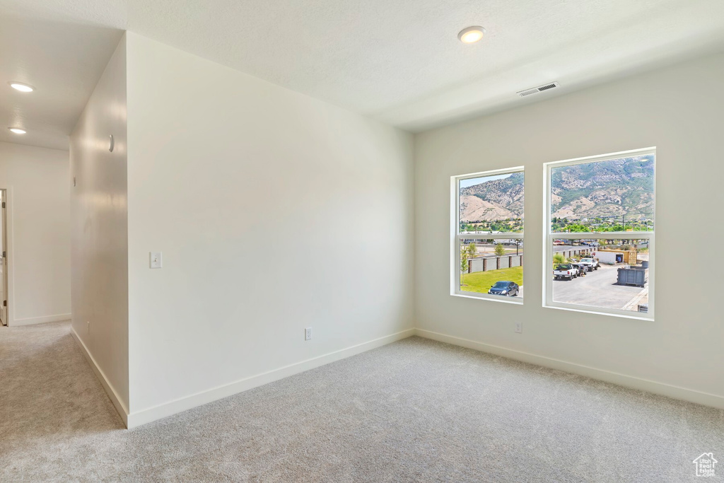 Unfurnished room with light carpet and recessed lighting