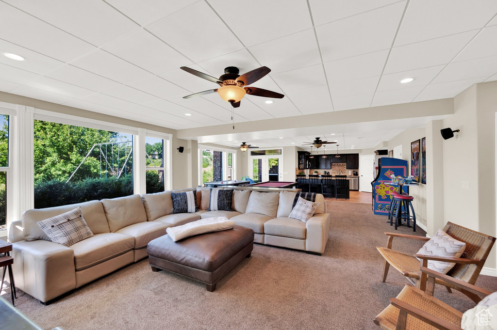 Living room with ceiling fan, recessed lighting, and light colored carpet
