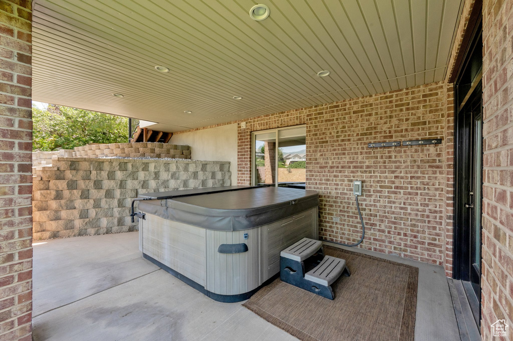 View of patio / terrace with a hot tub