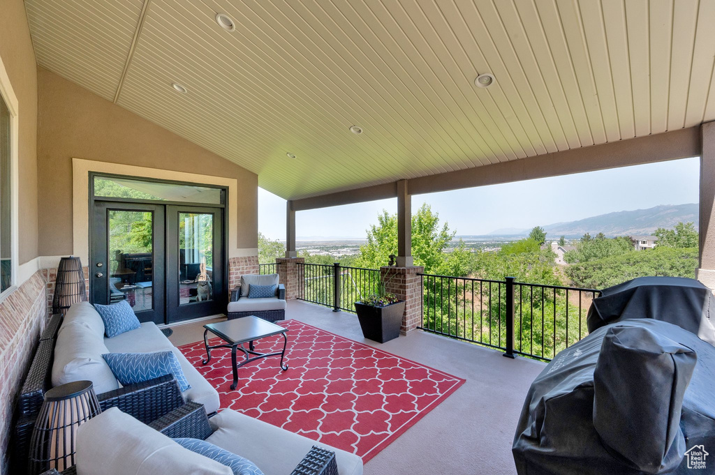 View of patio / terrace with outdoor lounge area, grilling area, french doors, and a mountain view