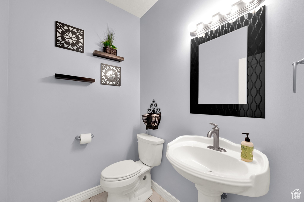 Bathroom with a sink and tile patterned flooring
