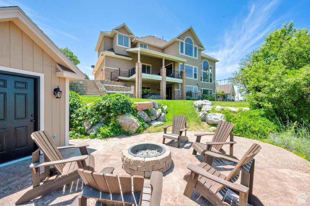 View of patio featuring a fire pit