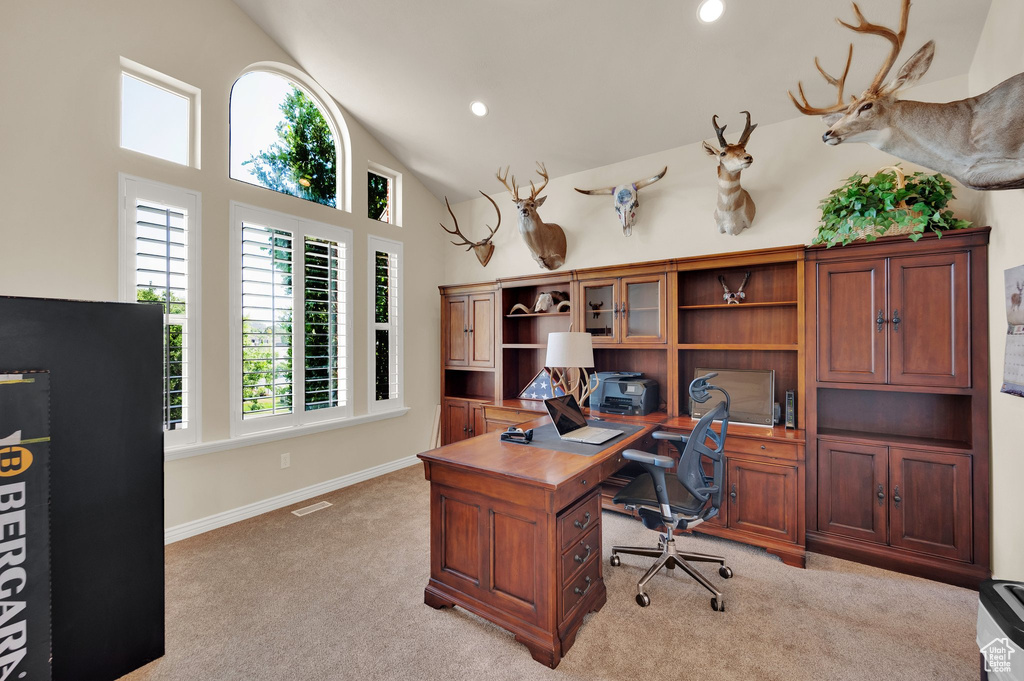 Home office with light colored carpet, high vaulted ceiling, and recessed lighting
