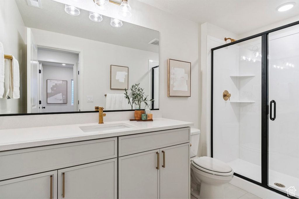Bathroom featuring vanity, a shower stall, and tile patterned floors