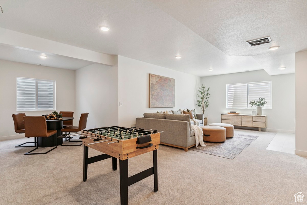 Game room with light colored carpet and recessed lighting