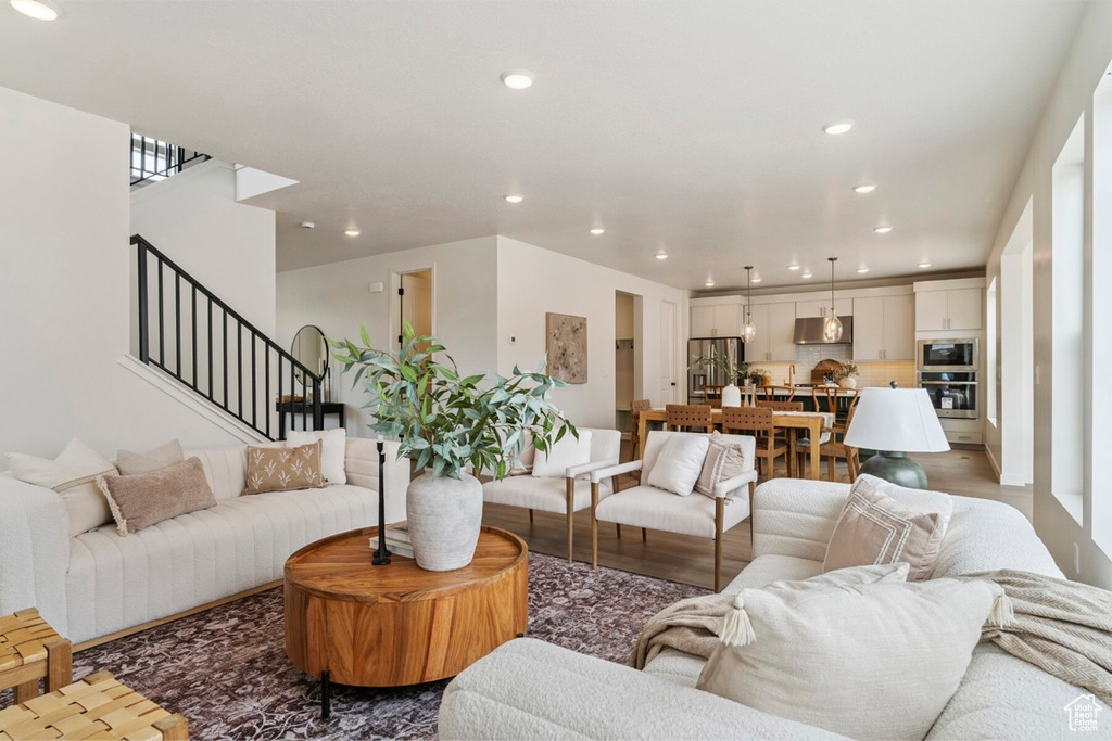 Living room featuring recessed lighting, stairs, and wood finished floors