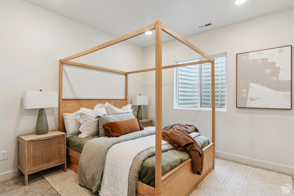 Bedroom featuring light carpet and recessed lighting