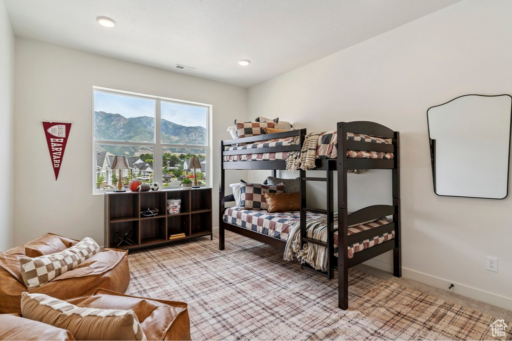Bedroom with carpet and a mountain view