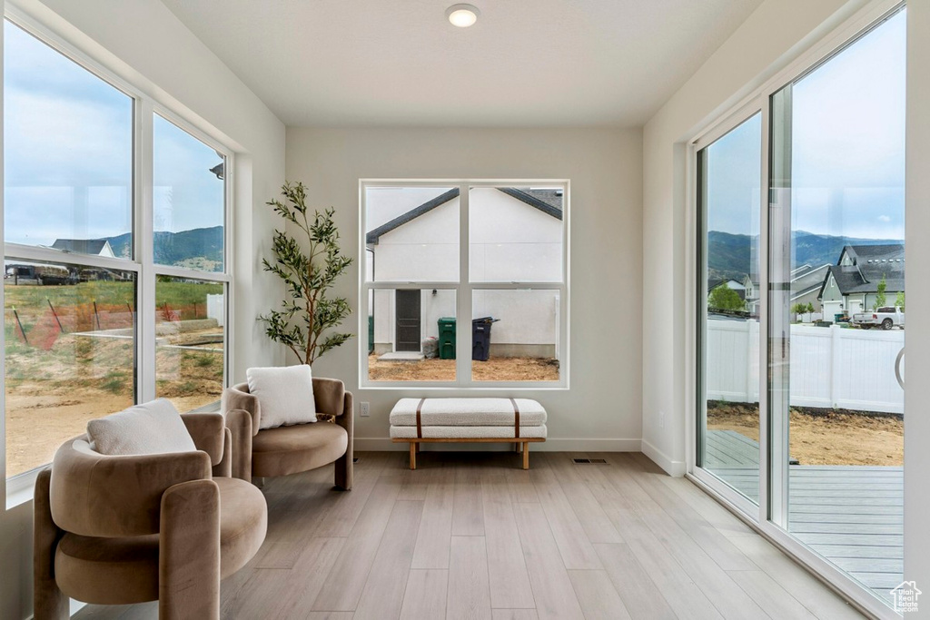 Sunroom featuring a mountain view and plenty of natural light