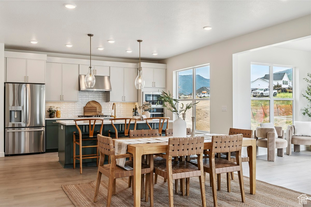 Dining area featuring light wood-style floors and recessed lighting