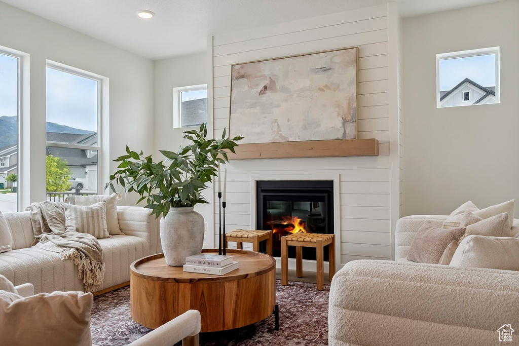 Living area featuring healthy amount of natural light, a glass covered fireplace, and recessed lighting
