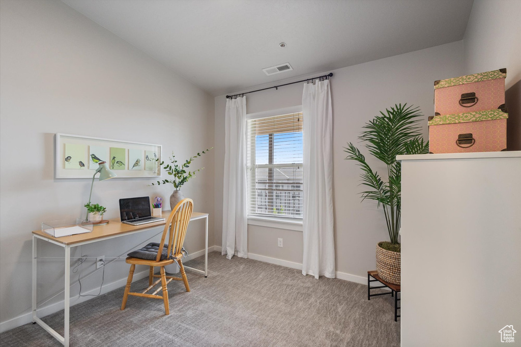Carpeted office with baseboards