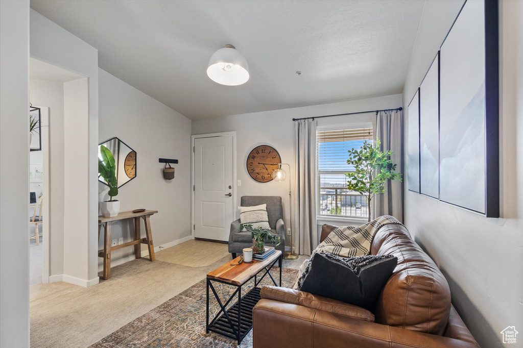 Carpeted living area with baseboards