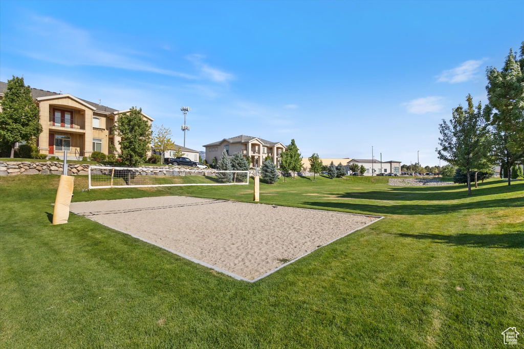 View of home's community featuring volleyball court, a lawn, and a residential view