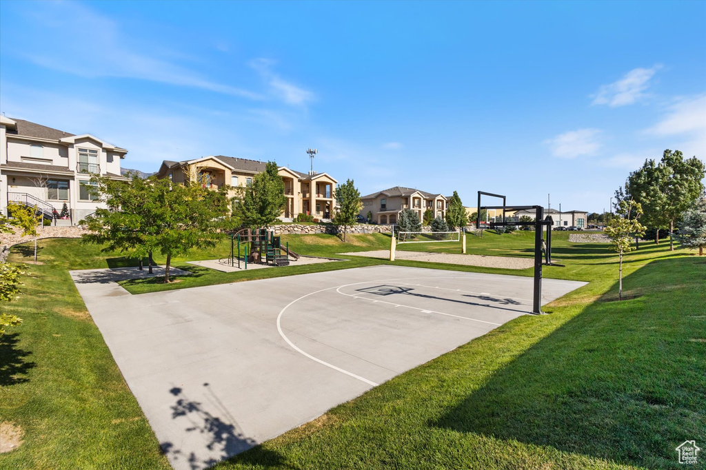 View of sport court with a residential view, a yard, and community basketball court