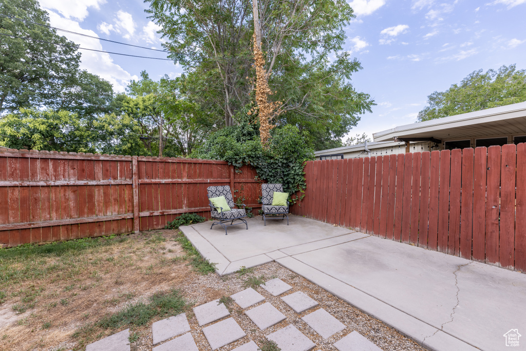 Fenced backyard featuring a patio
