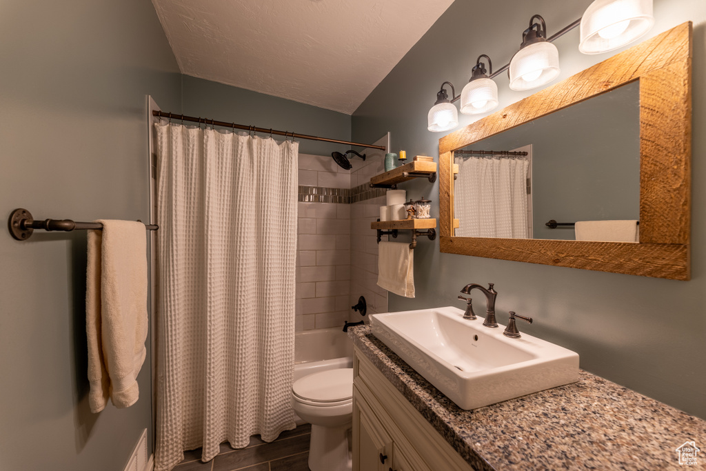 Full bath featuring vanity, shower / bathtub combination with curtain, and wood finished floors