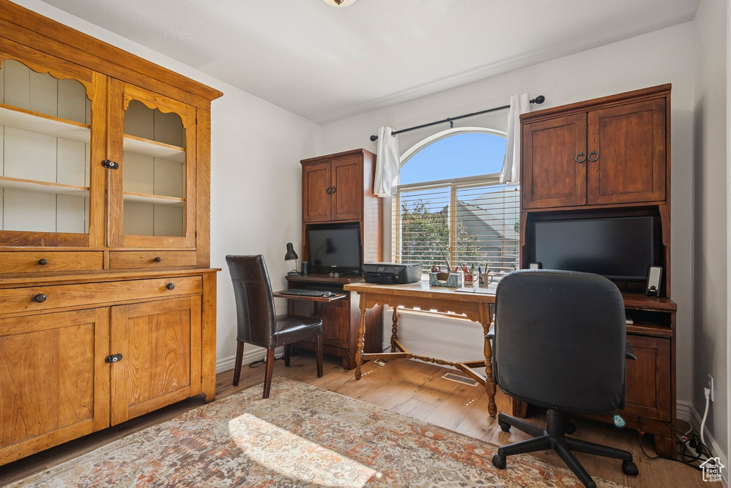 Office space with light wood-type flooring