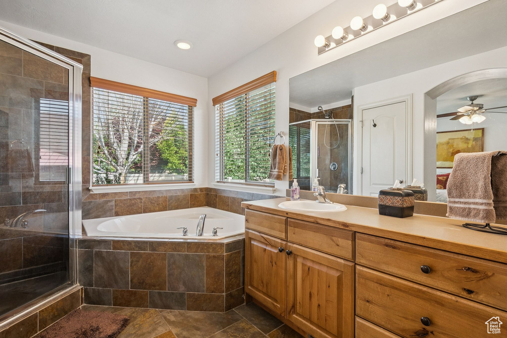 Bathroom featuring vanity, a garden tub, a shower stall, ceiling fan, and recessed lighting