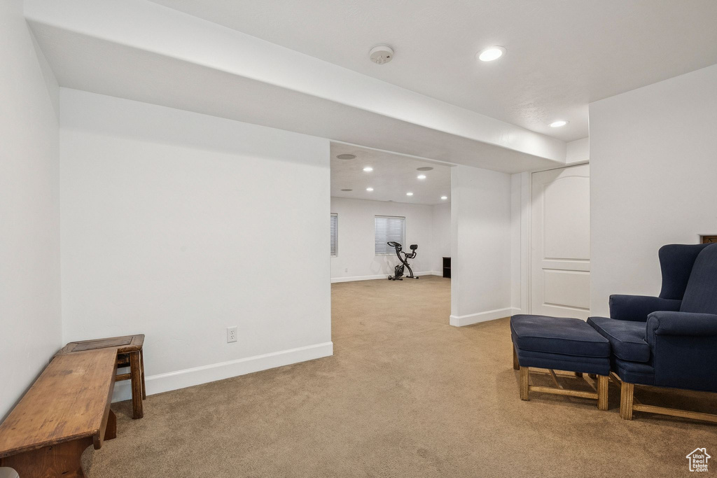 Living area featuring light colored carpet and recessed lighting