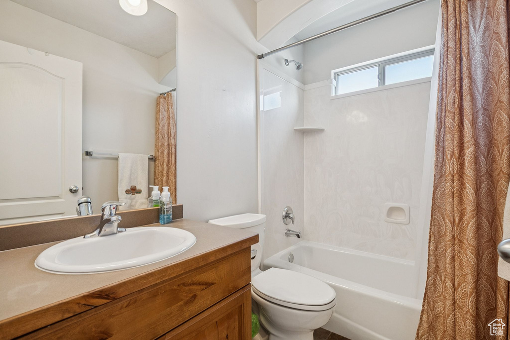 Full bathroom with shower / bathtub combination with curtain and vanity