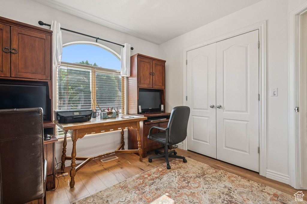 Office with light wood-style floors