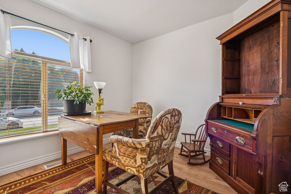 Office with light wood-style flooring and baseboards