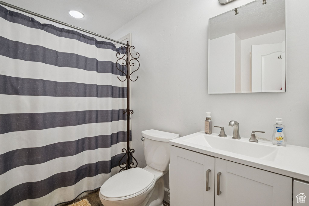 Full bath featuring vanity, recessed lighting, and a shower with shower curtain