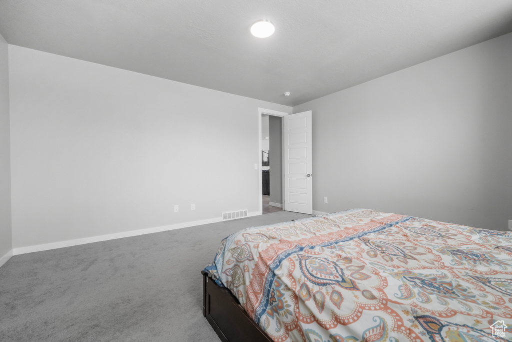 Carpeted bedroom featuring baseboards