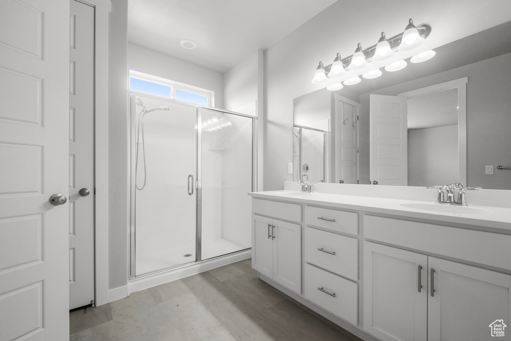 Bathroom with double vanity and a shower stall