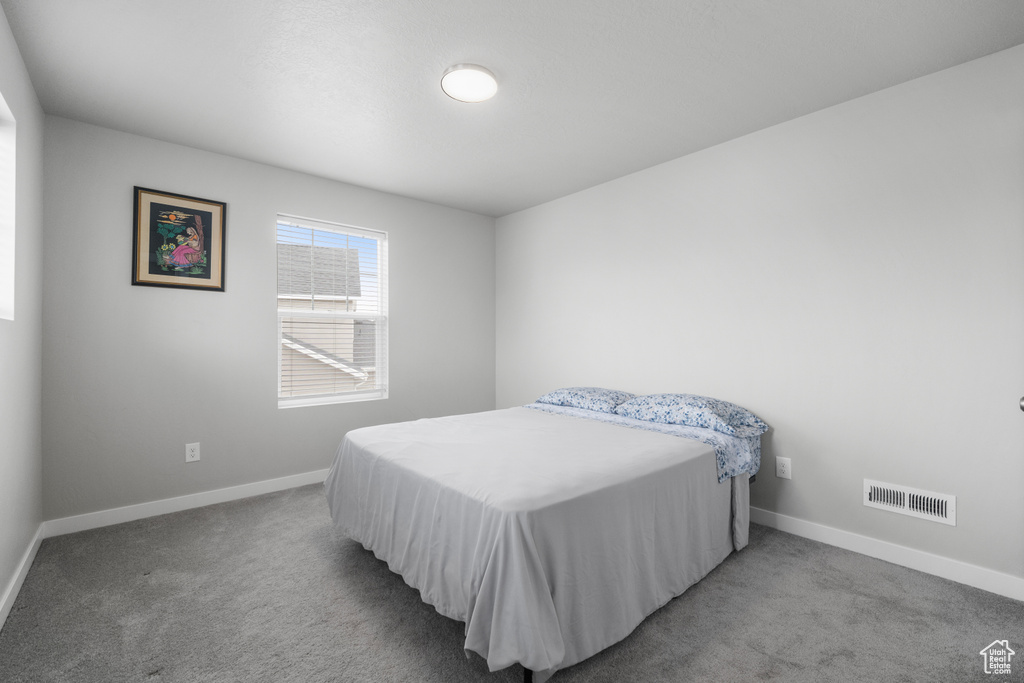 Carpeted bedroom with baseboards