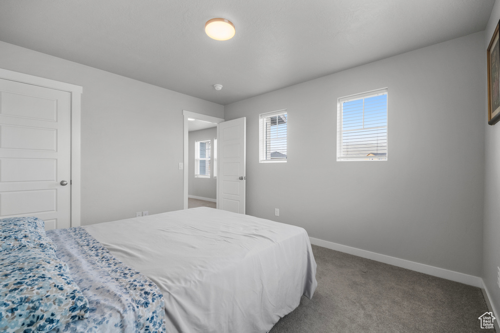 Carpeted bedroom featuring baseboards